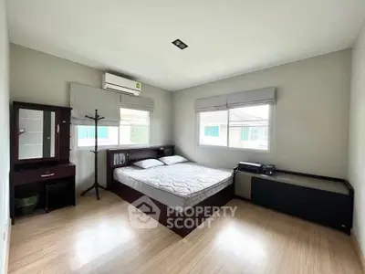 Spacious bedroom with modern furnishings and natural light