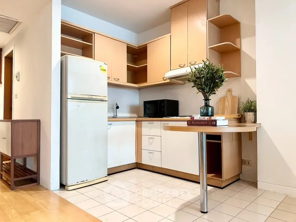 Charming kitchen with open layout and modern appliances in cozy apartment.