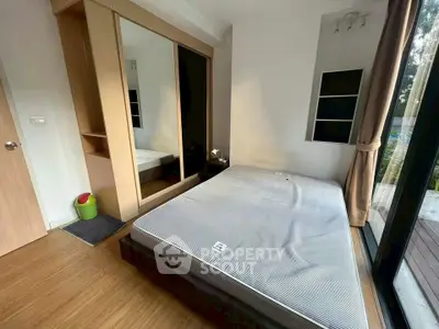 Modern bedroom with large mirror wardrobe and natural light