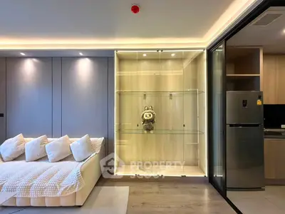 Modern living room with cozy sofa and glass display cabinet in stylish apartment.