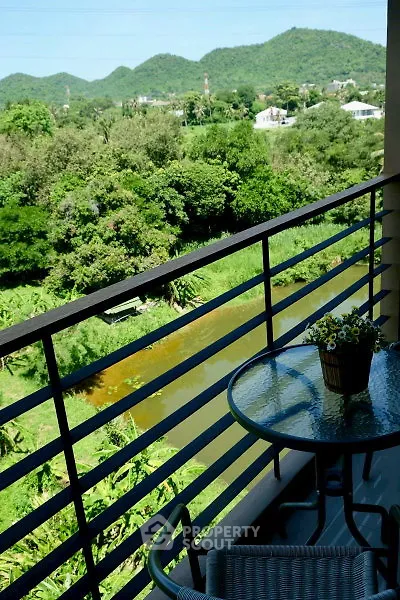 Charming balcony with scenic mountain and river view, perfect for relaxation.