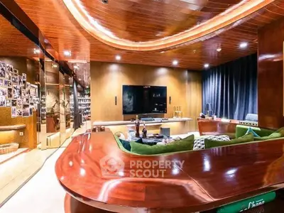 Luxurious home entertainment room with plush seating and large TV
