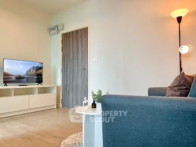 Modern living room with stylish furniture and flat-screen TV, perfect for relaxation and entertainment.