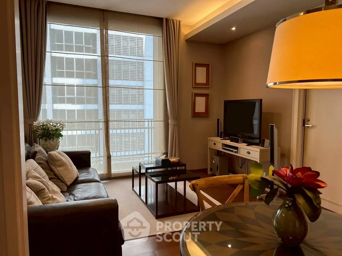 Stylish living room with modern decor and large windows in a high-rise apartment.
