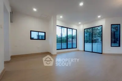 Spacious modern living room with large windows and natural light