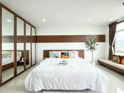 Spacious modern bedroom with large windows and stylish decor