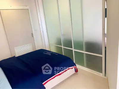 Cozy bedroom with frosted glass sliding doors and modern decor