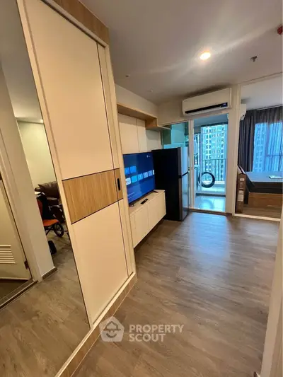 Modern apartment interior with sleek design, featuring a spacious living area and balcony view.