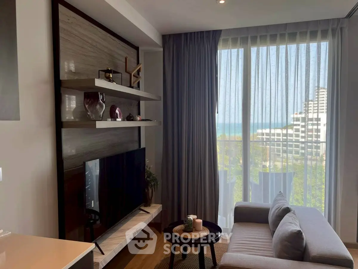 Modern living room with ocean view, stylish decor, and natural light