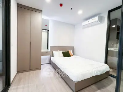 Modern bedroom with sleek design and air conditioning in a stylish apartment.