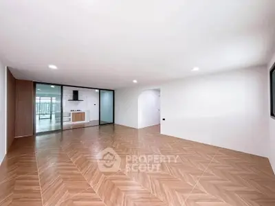 Spacious modern living room with open kitchen and elegant wood flooring