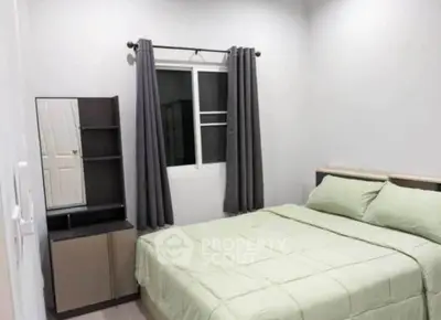 Cozy bedroom with modern furnishings and natural light, perfect for relaxation and comfort.