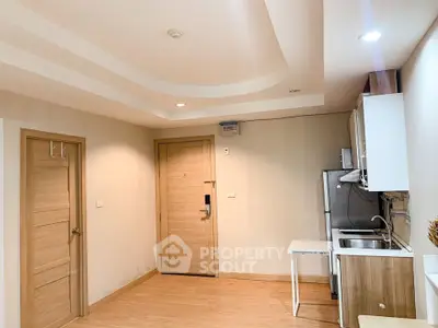 Modern apartment interior with sleek kitchen and wooden flooring