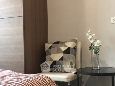 Cozy bedroom corner with modern decor and geometric cushion