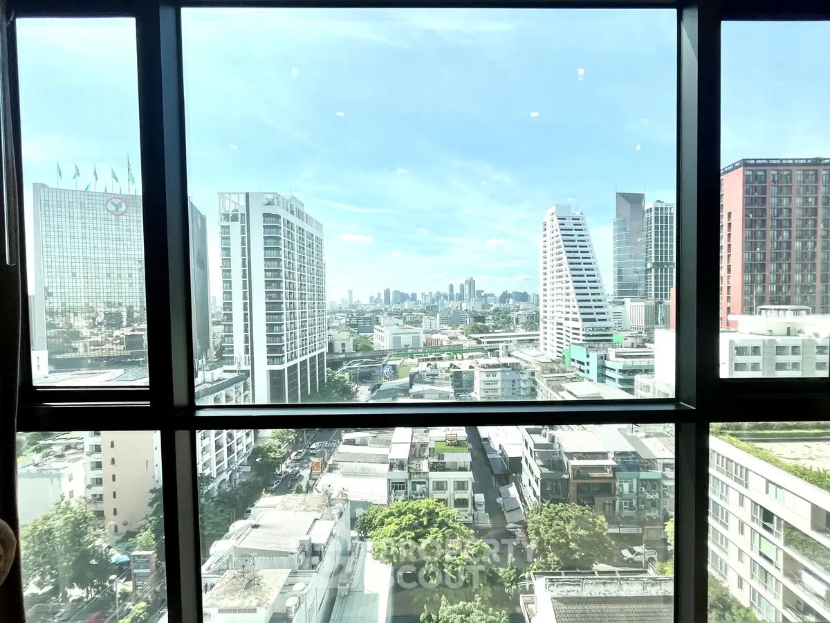 Stunning cityscape view from high-rise window showcasing urban skyline and modern architecture.