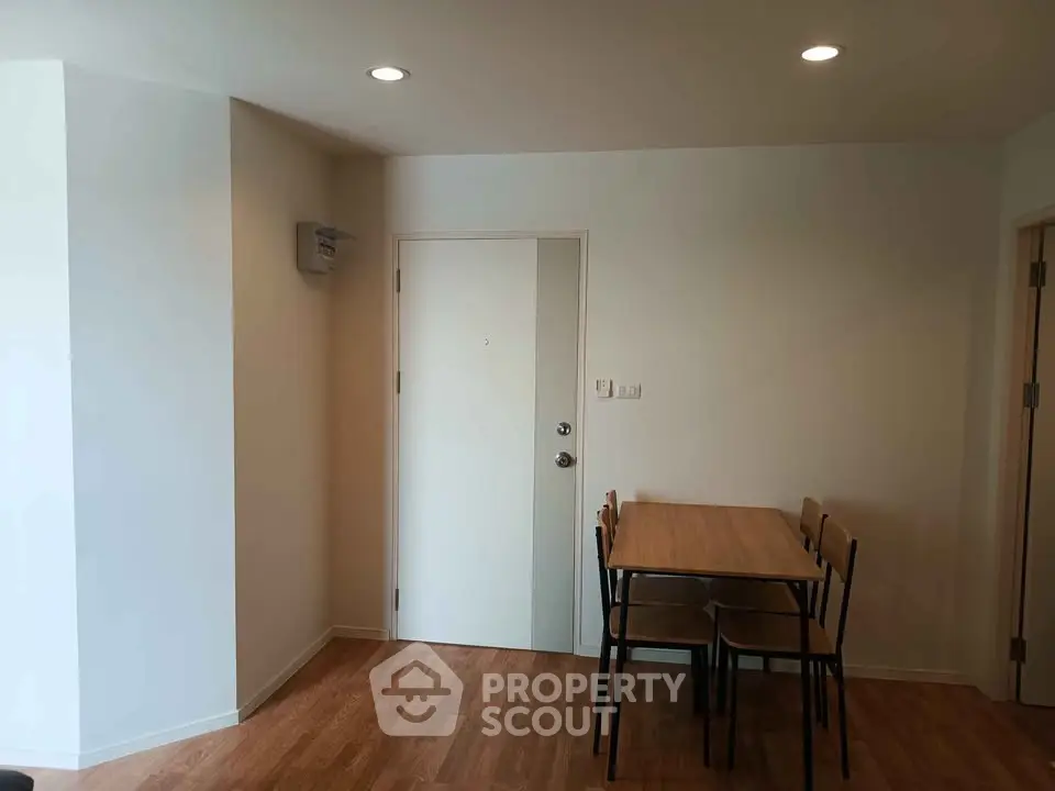 Minimalist dining area with wooden table and chairs in modern apartment
