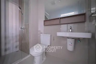 Modern bathroom with sleek fixtures and glass shower enclosure