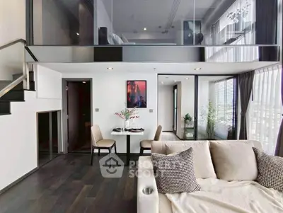 Modern duplex apartment with stylish living room and mezzanine bedroom, featuring sleek design and abundant natural light.