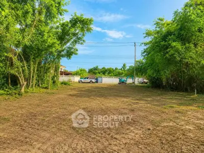 Spacious land plot surrounded by lush greenery, ideal for development or investment opportunities.