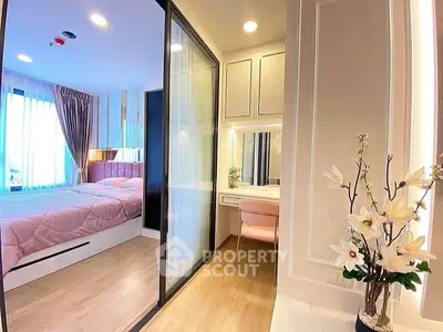 Modern bedroom with sliding glass doors and elegant decor in a stylish apartment.