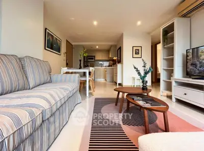 Stylish living room with modern decor and open kitchen layout