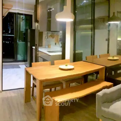 Modern dining area with wooden table and open kitchen layout
