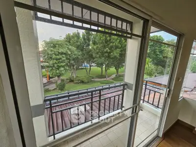 Spacious balcony with lush garden view in modern apartment