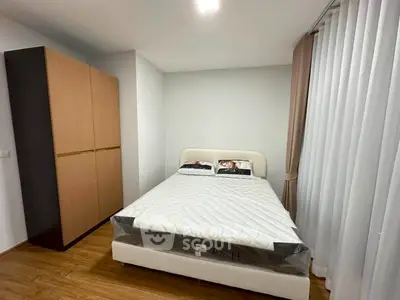 Cozy bedroom with modern wardrobe and comfortable bed in a stylish apartment.