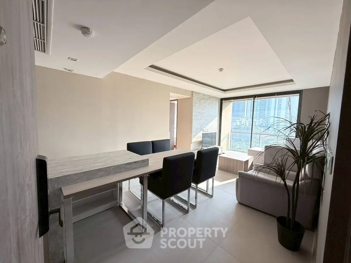 Modern dining and living area with city view in luxury apartment