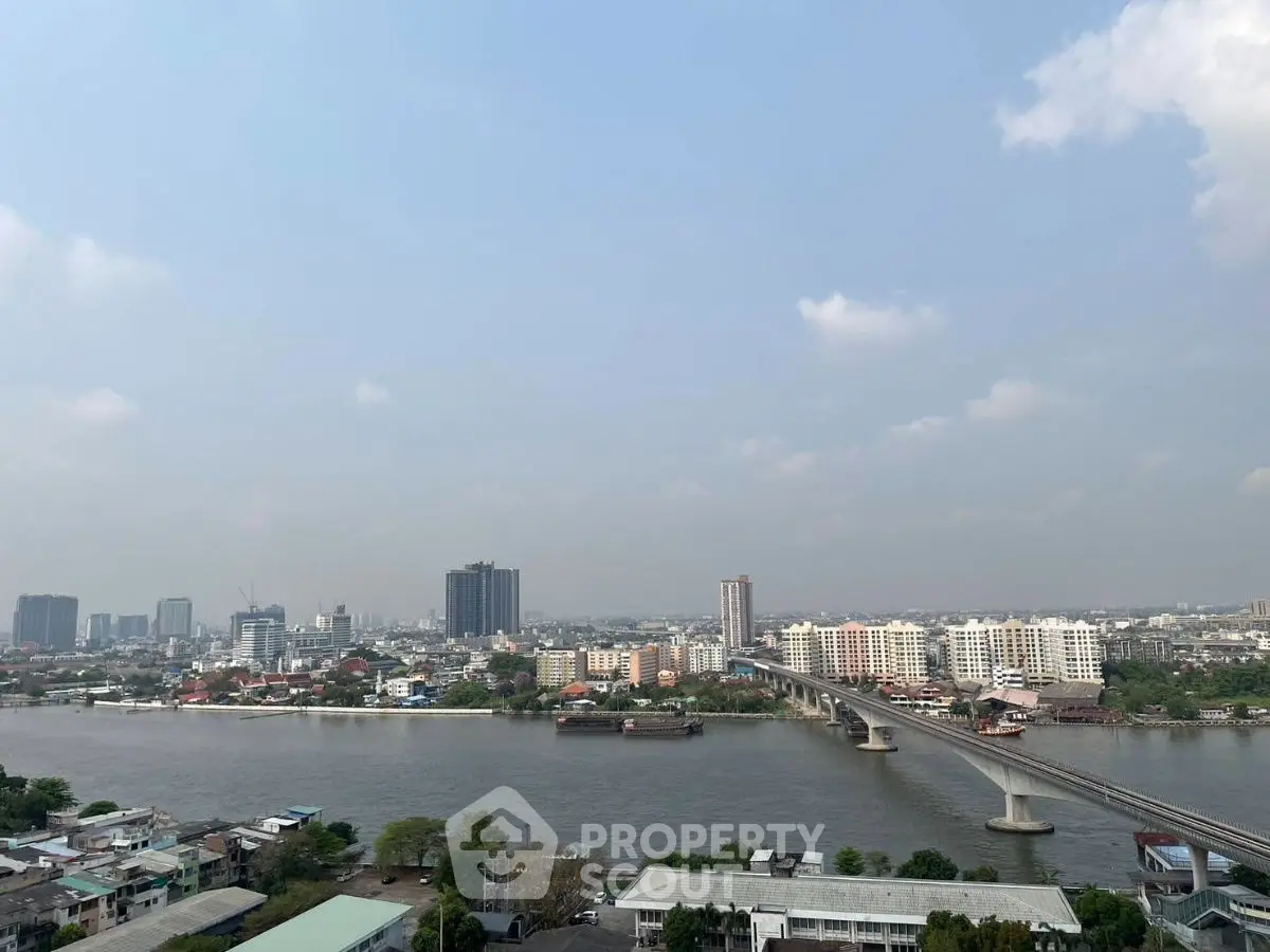 Stunning cityscape view with river and bridge, perfect for urban living enthusiasts.