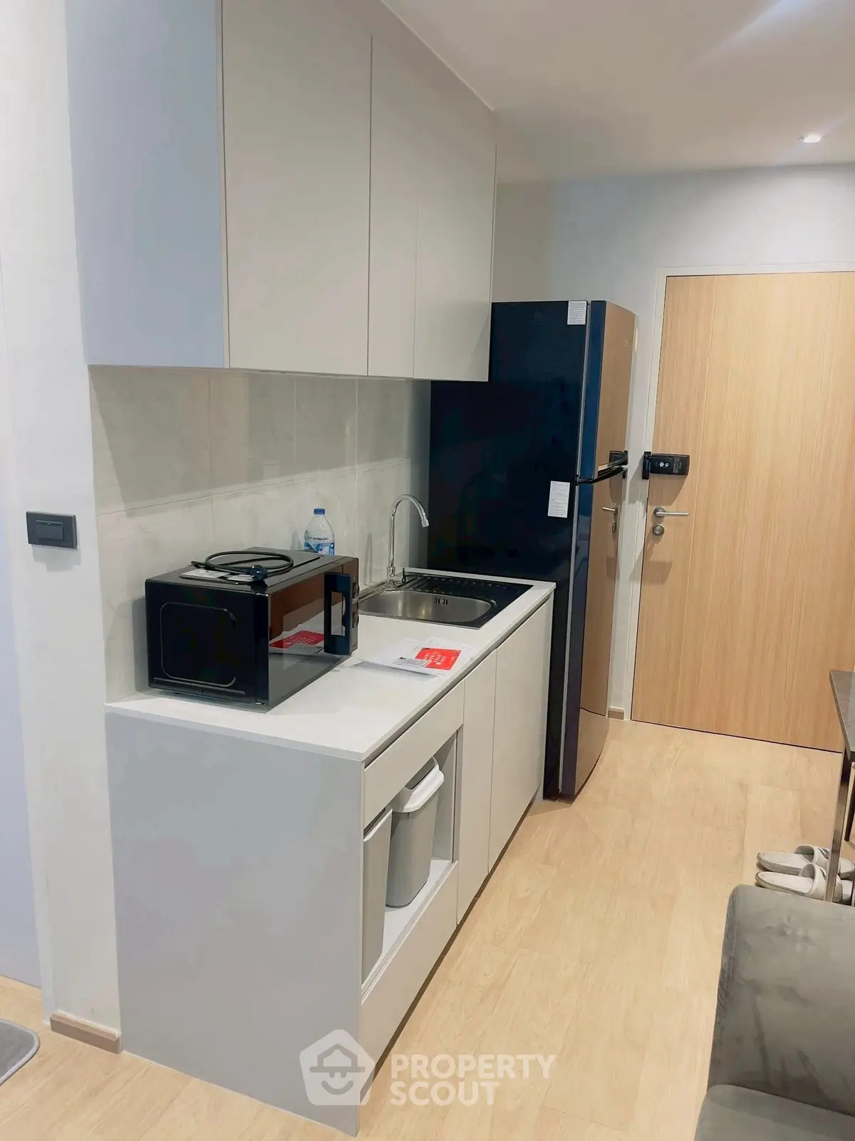 Modern compact kitchen with sleek appliances and minimalist design