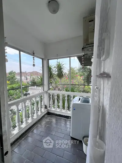 Charming balcony with garden view and washing machine setup