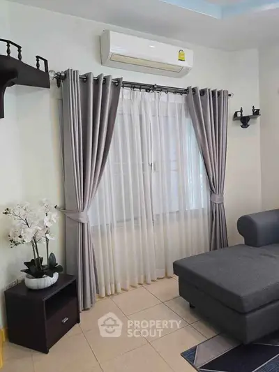 Modern living room with elegant curtains and air conditioning unit