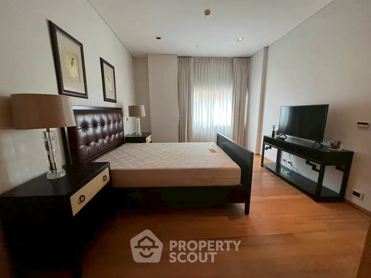 Spacious bedroom with modern furnishings and natural light