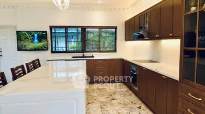 Luxurious kitchen with marble countertops and wooden cabinets in elegant home