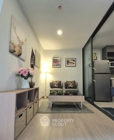 Modern living room with stylish decor and open kitchen layout in a cozy apartment.