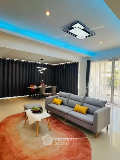 Modern living room with stylish decor, featuring a cozy sofa, elegant dining area, and ambient lighting.