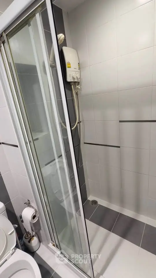 Modern bathroom with sleek shower enclosure and tiled walls