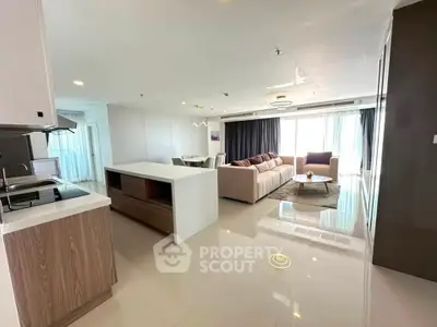 Spacious modern living room with open kitchen and elegant furnishings
