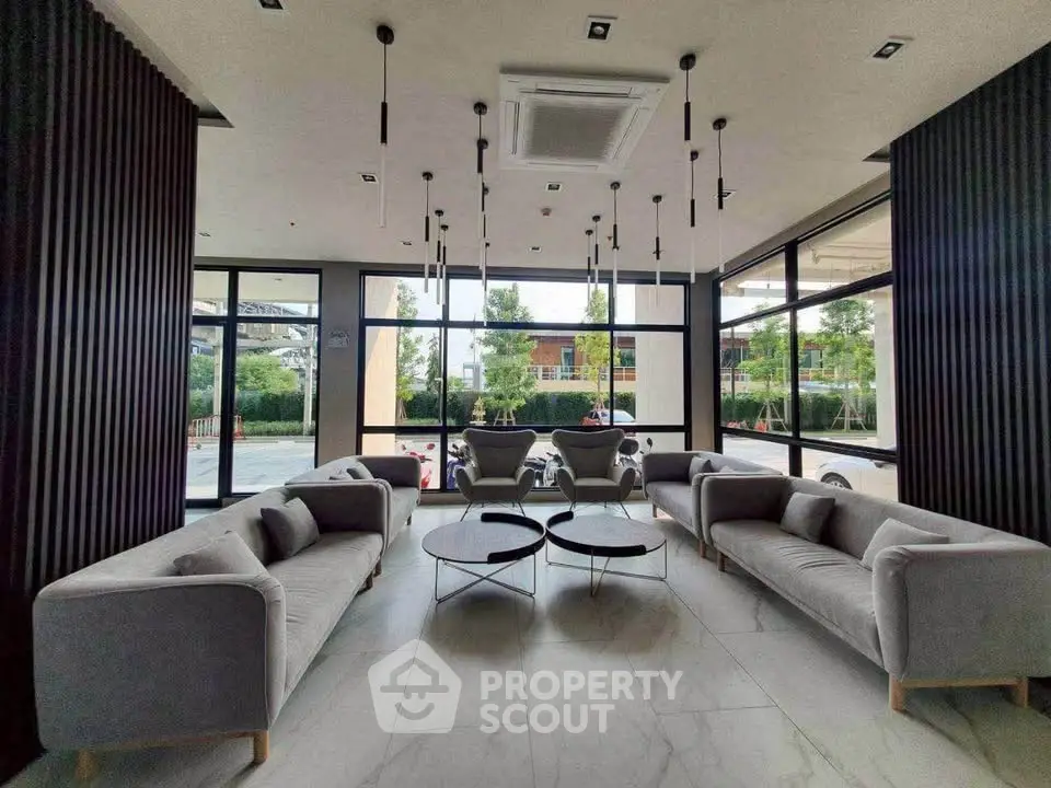 Modern lobby with stylish seating and large windows offering natural light.