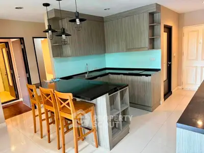 Modern kitchen with sleek cabinetry and breakfast bar in stylish apartment