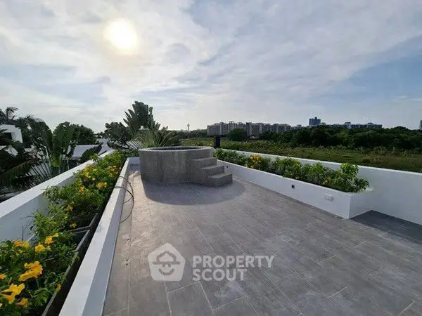 Stunning rooftop terrace with panoramic views and lush greenery, perfect for relaxation and entertainment.