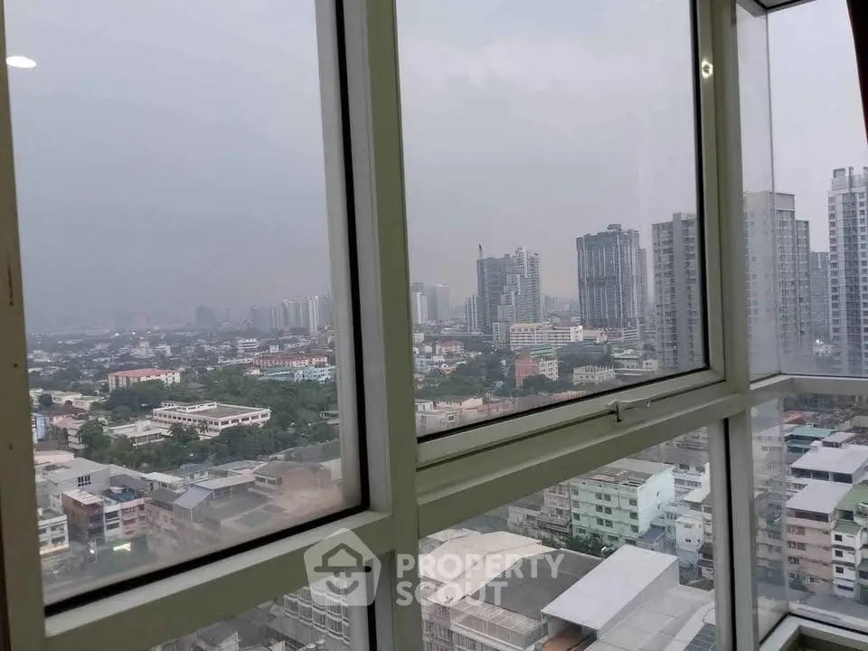 Stunning cityscape view from a high-rise apartment window, showcasing urban skyline and modern architecture.