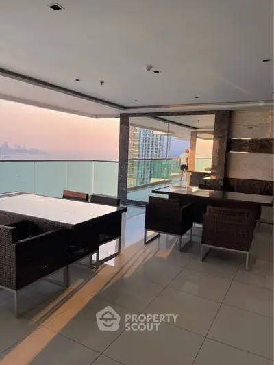 Luxurious balcony with stunning ocean view and elegant outdoor seating area.