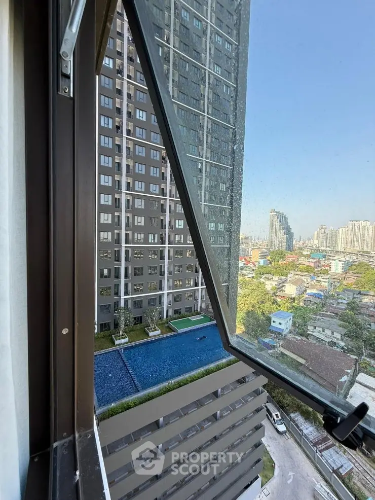 High-rise apartment view with pool and cityscape