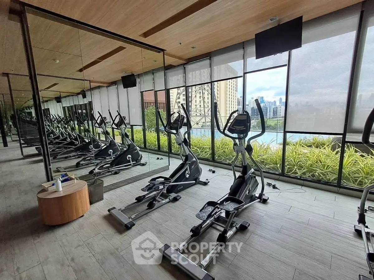 Modern gym with city view and state-of-the-art equipment