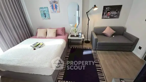 Stylish bedroom with cozy seating area and modern decor