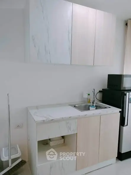 Modern kitchen with sleek cabinetry and compact appliances, perfect for urban living.