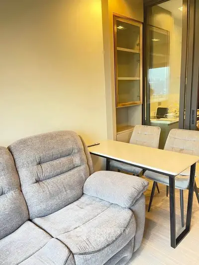 Modern living room with cozy sofa and stylish dining area in a bright apartment.
