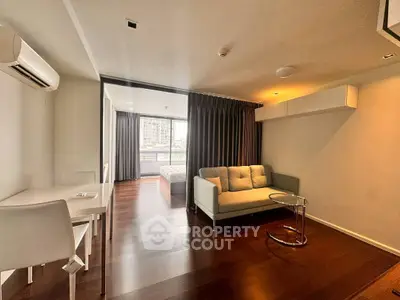 Modern living room with sleek furniture and city view balcony